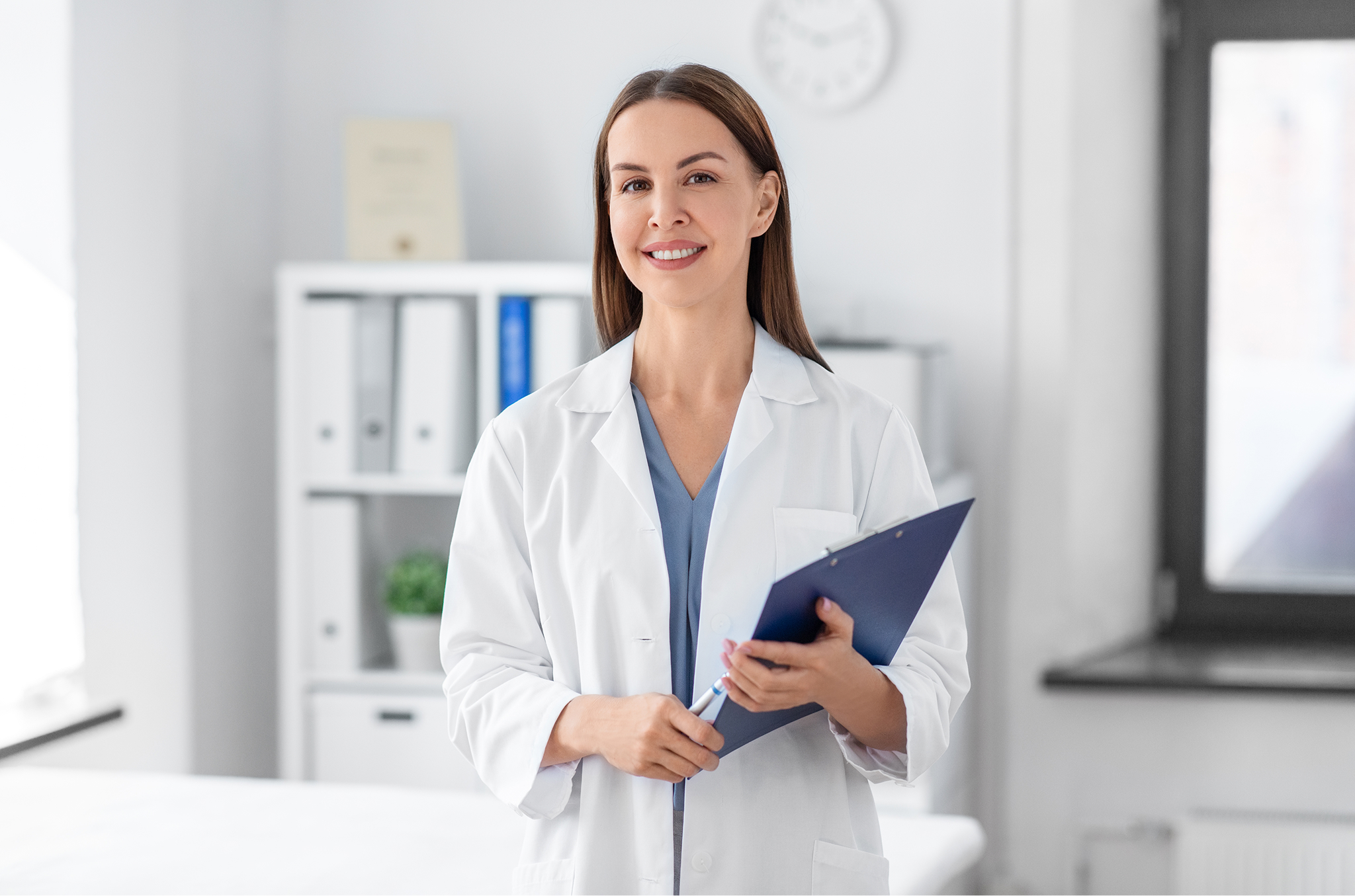 smiling-female-doctor-with-clipboard-hospital 1